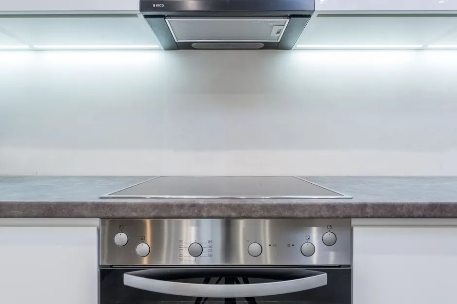 A sleek, modern kitchen with steel appliances and minimalist design.
